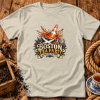 Light-colored t-shirt featuring a graphic with a traffic cone submerged in a Scottish-flag-patterned teacup, text reading Boston Tea Party, and tea leaves.