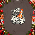 Christmas t-shirt graphic of an otter wearing a Santa hat, holding a traffic cone, with text "Otterly Merry".