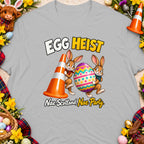 Two cartoon rabbits carry a large Easter egg and traffic cone with text "Egg Heist Nae Scotland, Nae Party".
