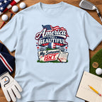 Light blue t-shirt featuring a patriotic golf graphic with text that reads America the Beautiful My Scorecard Isn't.