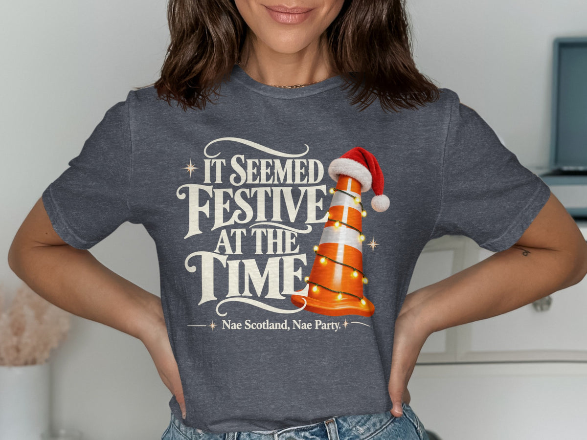 Dark grey t-shirt with "It Seemed Festive At The Time" and a traffic cone with Santa hat.