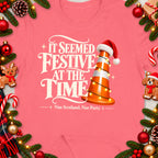 Pink t-shirt with "It Seemed Festive At The Time" and a traffic cone with Santa hat.