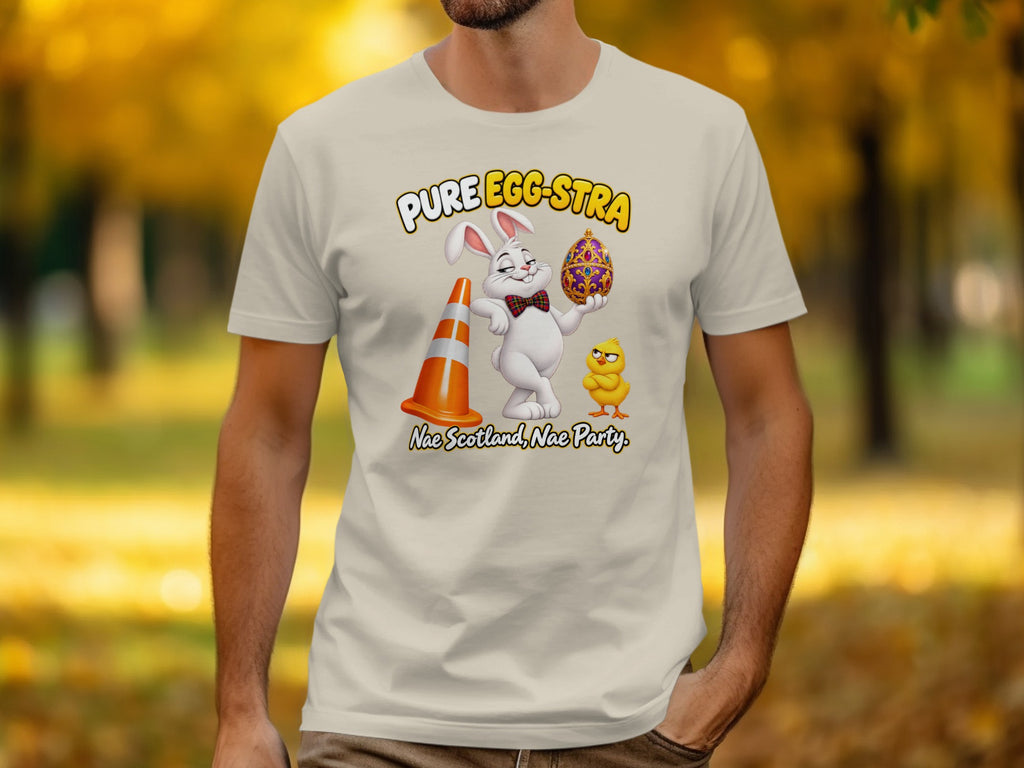 T-shirt with cartoon Easter bunny holding an egg, chick, and traffic cone. Text reads "Pure Egg-stra".