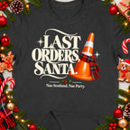 Dark t-shirt with "Last Orders Santa." text and orange traffic cone wearing scarf.