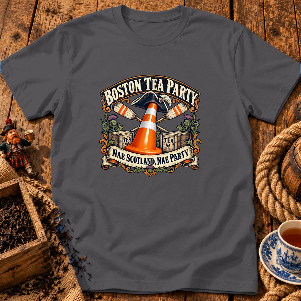 A dark grey t-shirt featuring a graphic with a traffic cone, tea crates, oars, and text reading Boston Tea Party and Nae Scotland, Nae Party.