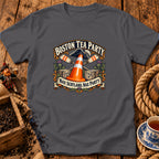 A dark grey t-shirt featuring a graphic with a traffic cone, tea crates, oars, and text reading Boston Tea Party and Nae Scotland, Nae Party.