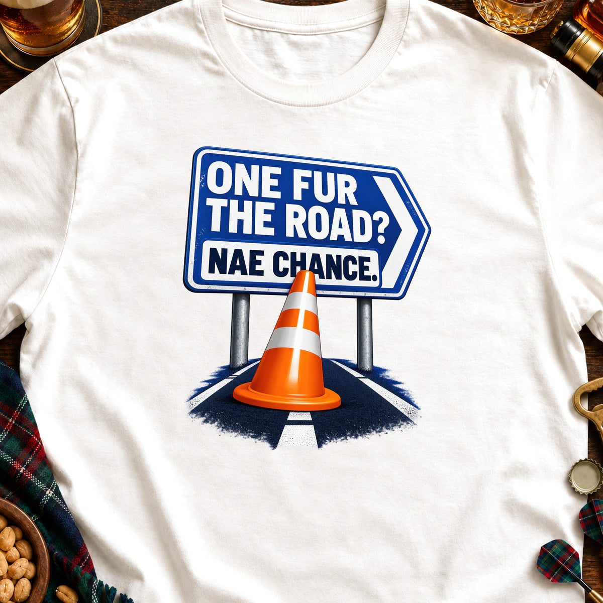 White t-shirt with graphic of blue sign reading "ONE FUR THE ROAD? NAE CHANCE."