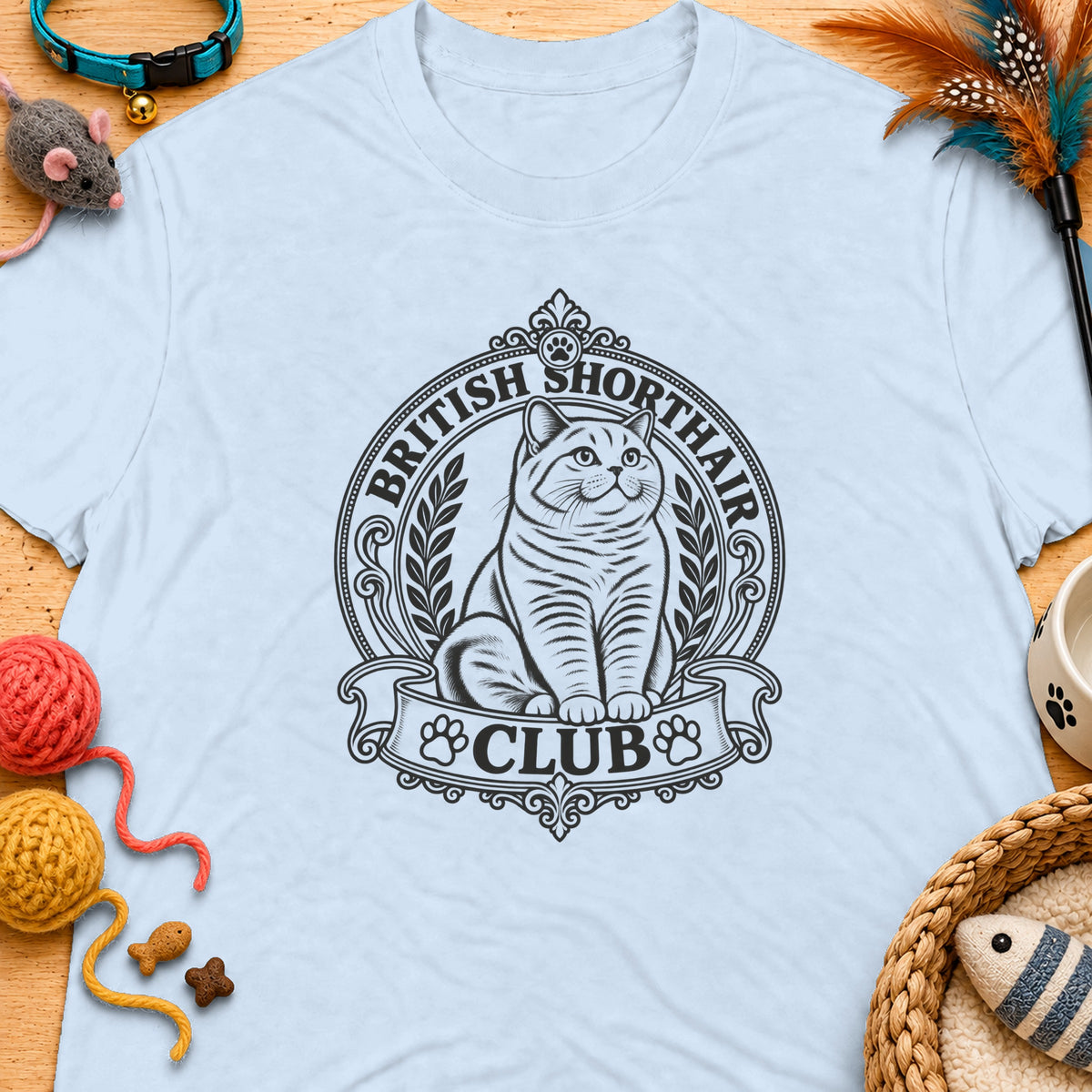 British Shorthair Club logo with cat on a light blue t-shirt.