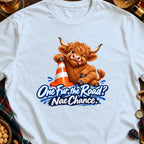 Cartoon Highland cow winks with tongue out, leaning on traffic cone, text "One Fur the Road? Nae Chance."
