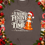 T-shirt with "It Seemed Festive At The Time" and "Nae Scotland, Nae Party" text.