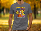 T-shirt with three cartoon chicks celebrating around a traffic cone and egg.