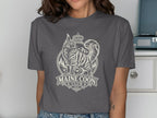 Maine Coon Club graphic with a crowned cat, mountains, and trees on a t-shirt.