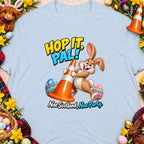 Cartoon rabbit holds orange traffic cone and eggs with text "Hop it, pal!"