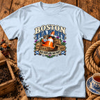 Light blue t-shirt featuring a graphic with a traffic cone, teacups, and text reading Boston Tea Party.