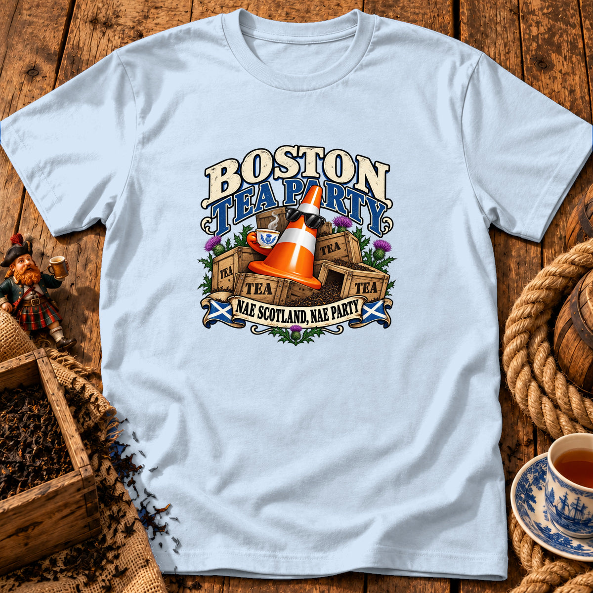 Light blue t-shirt featuring a graphic with a traffic cone, teacups, and text reading Boston Tea Party.