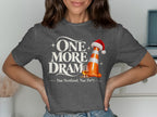 Dark grey t-shirt with "One More Dram" text, a traffic cone with a Santa hat, and a glass of whisky.