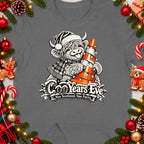 Highland cow in Santa hat holding Christmas lights on cone with "Coo Years Eve" text.