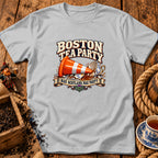 Light gray t-shirt featuring a graphic with an orange traffic cone, a smashed teacup, and text reading Boston Tea Party Nae Scotland, Nae Party.