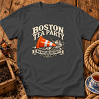 A dark gray t-shirt featuring a Boston Tea Party graphic with a traffic cone and shattered teacup.