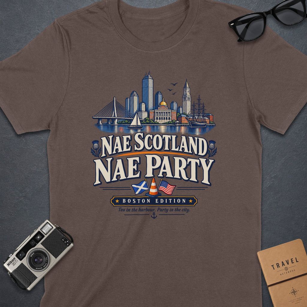 Brown t-shirt graphic with Boston skyline, "Nae Scotland Nae Party," and flags.