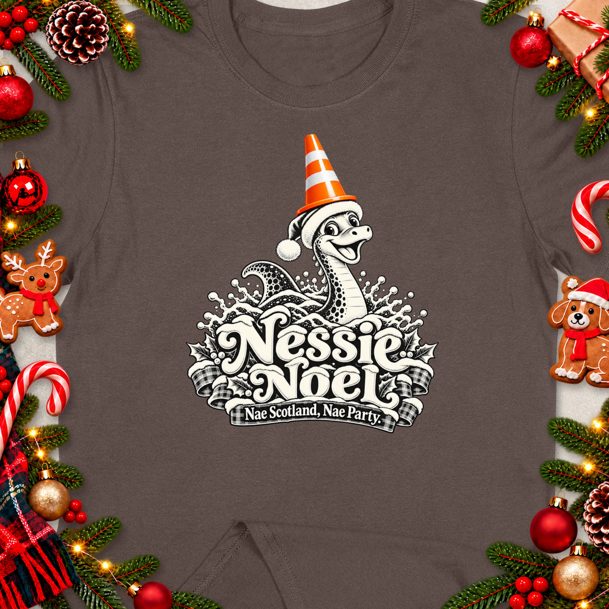 Nessie Noel graphic with "Nae Scotland, Nae Party." text on a brown t-shirt.