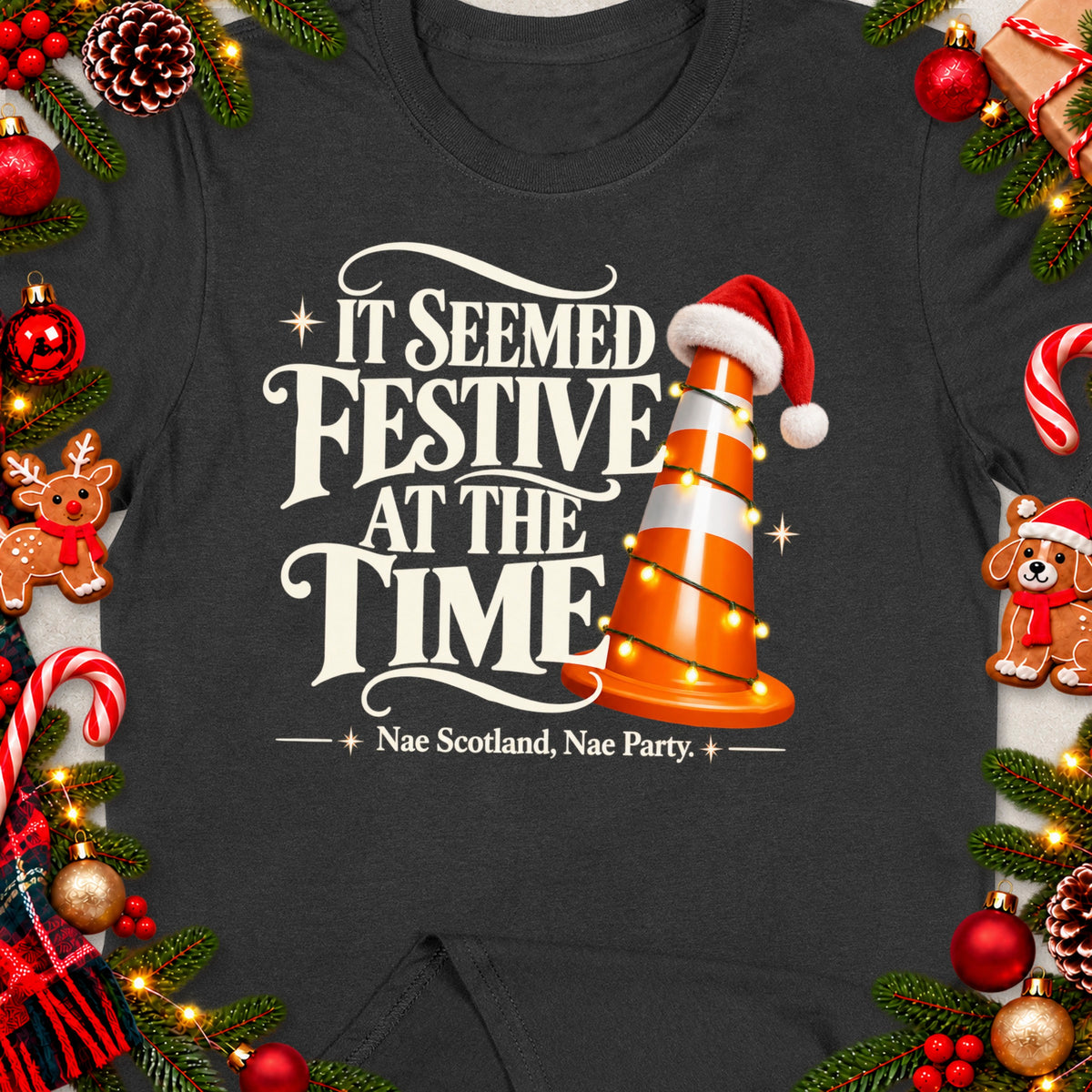 Dark t-shirt with text "It Seemed Festive At The Time Nae Scotland, Nae Party." and a traffic cone.