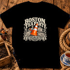 Black t-shirt featuring a Boston Tea Party design with an orange traffic cone, crates, and text.