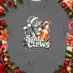 T-shirt graphic of a cat in a Santa hat with "Santa Claws Nae Scotland, Nae Party" text.