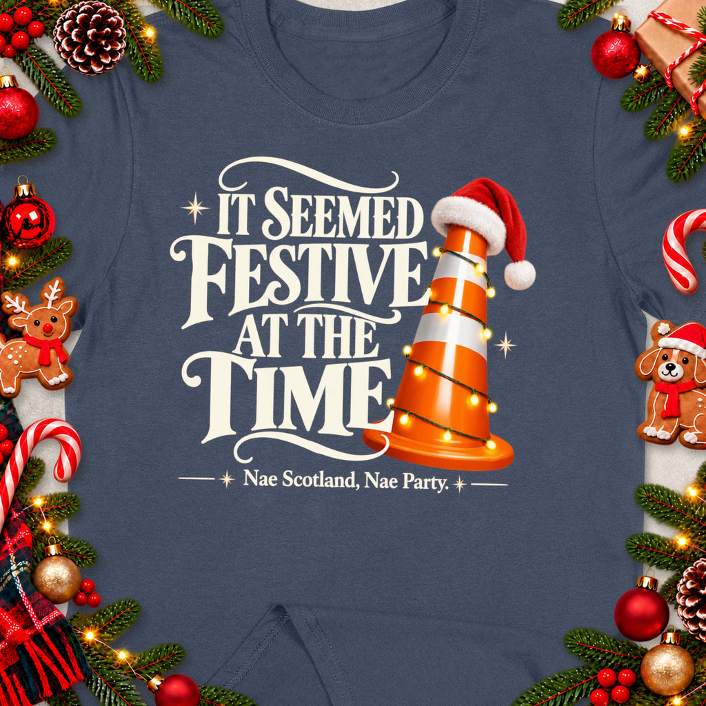 T-shirt with text "It Seemed Festive At The Time Nae Scotland, Nae Party" and a traffic cone.