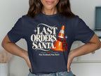 Navy t-shirt with "Last Orders, Santa" text and an orange traffic cone with a tartan scarf.