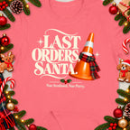 T-shirt with "Last Orders Santa" text, traffic cone, and Scottish holiday phrase.