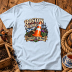 Light blue t-shirt featuring a graphic with a traffic cone, Scottish flag, and text reading Boston Tea Party Nae Scotland Nae Party.