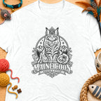 White t-shirt with black graphic of a crowned Maine Coon cat, mountains, and text.