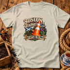 Light beige t-shirt with a Boston Tea Party design featuring a traffic cone, Scottish flag, and ship.