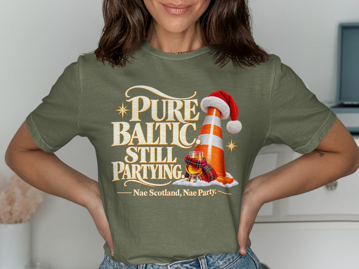 T-shirt graphic with traffic cone, Santa hat, whisky, and text "Pure Baltic Still Partying".