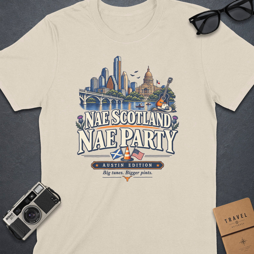 Cream t-shirt graphic with "Nae Scotland Nae Party Austin Edition" text and Austin skyline.
