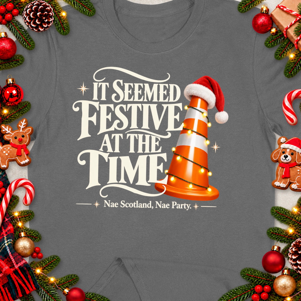 T-shirt with text "It seemed festive at the time" and a traffic cone with Santa hat.