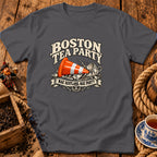 Dark grey t-shirt featuring a graphic with an orange traffic cone inside a smashed teacup and text reading BOSTON TEA PARTY and NAE SCOTLAND, NAE PARTY.