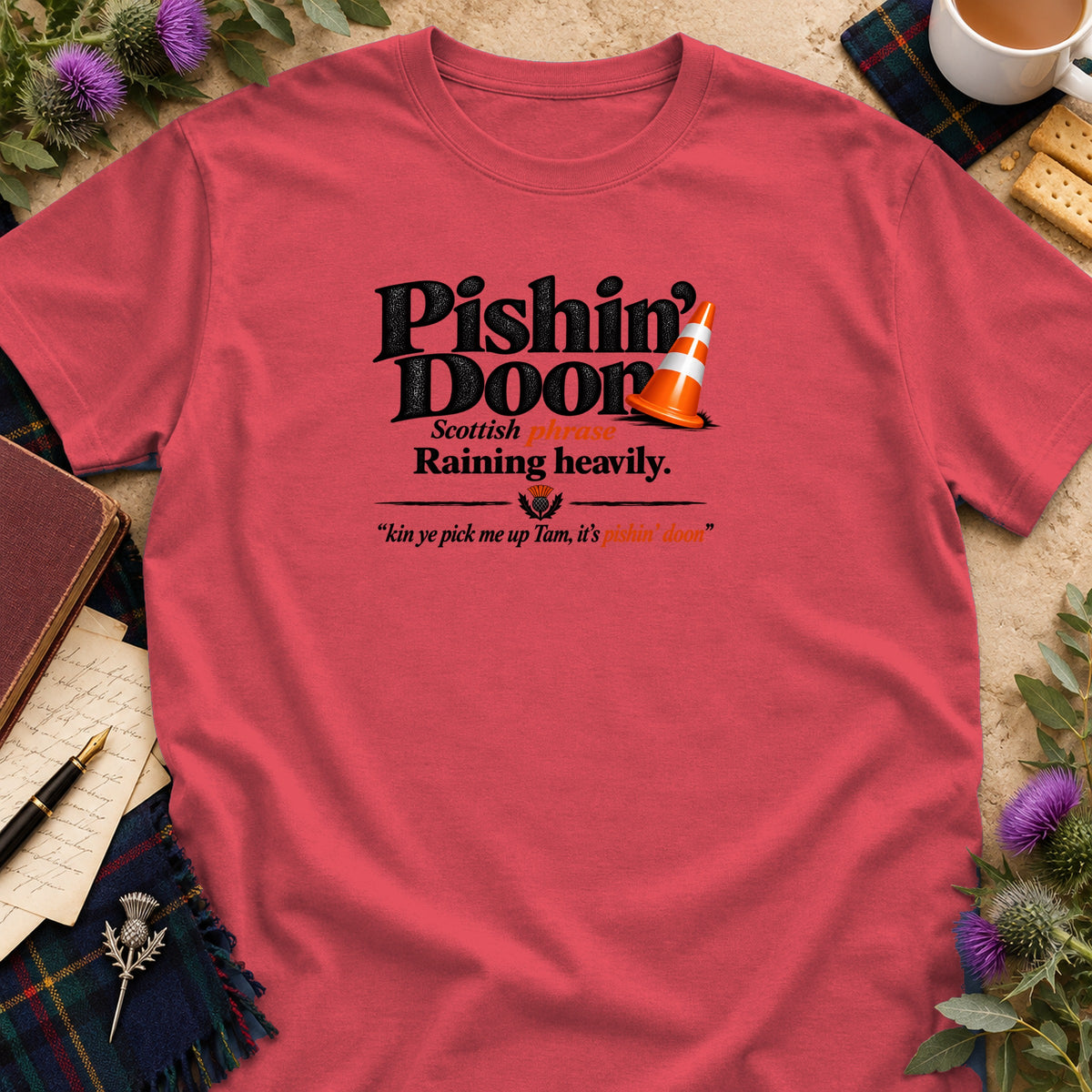 Coral pink crewneck t-shirt featuring black text that reads Pishin Doon with a traffic cone graphic.