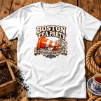 A white t-shirt features a graphic with text reading "Boston Tea Party" and "Nae Scotland, Nae Party," showing a traffic cone crushing a teacup.