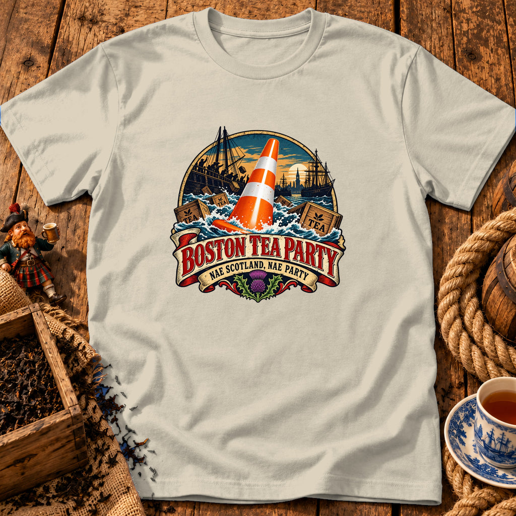 Light-colored t-shirt featuring a Boston Tea Party graphic with a traffic cone floating among crates in the sea.