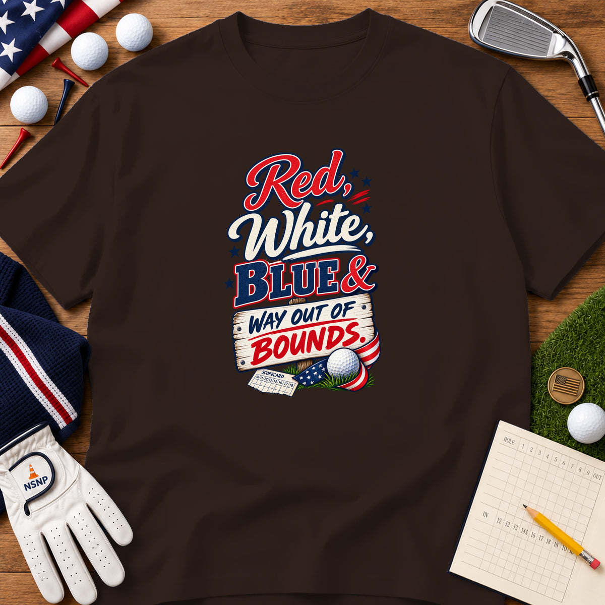 Brown t-shirt featuring a golf-themed patriotic graphic surrounded by golf equipment on a wooden surface.