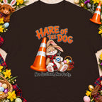 Brown t-shirt with a rabbit drinking coffee next to a traffic cone and Easter basket.