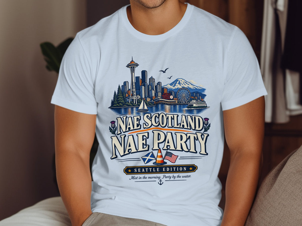 White t-shirt with Seattle skyline, mountains, and text "Nae Scotland Nae Party".