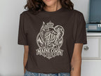 Brown t-shirt with a white graphic of a Maine Coon cat, crown, and text "MAINE COON -CLUB-".
