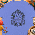 British Shorthair Club logo featuring a British Shorthair cat on a purple t-shirt.