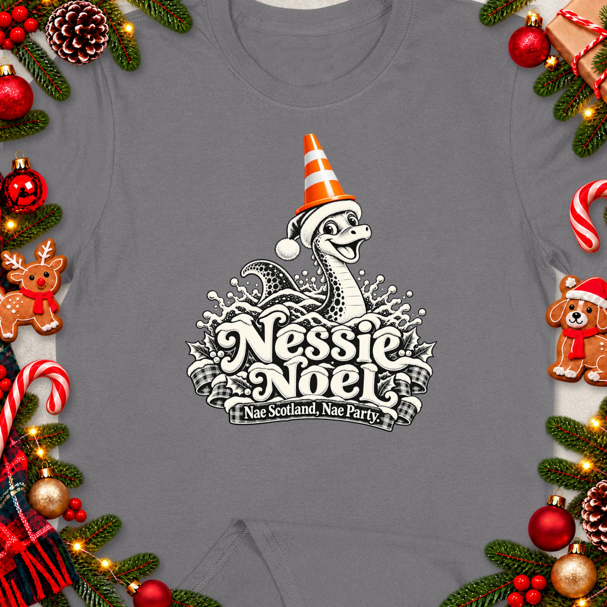 Nessie Noel design on gray t-shirt with holiday decorations and text.