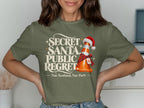 Khaki t-shirt with "Secret Santa Public Regret" and a traffic cone.